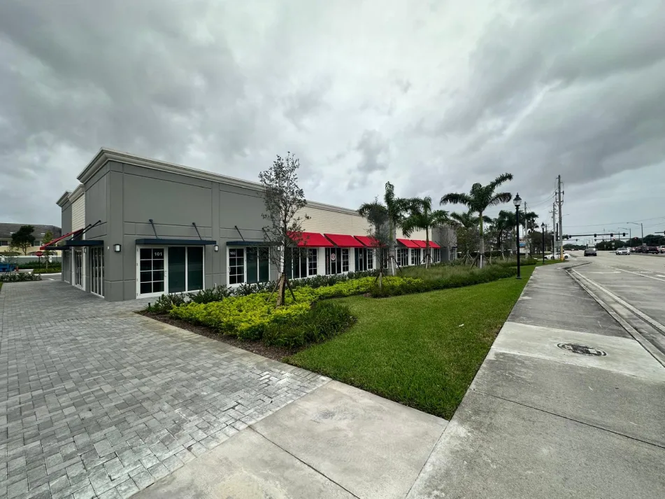 Commercial interior buildout with metal stud wall framing over raw concrete floor
