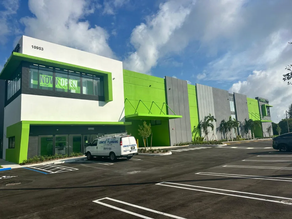 New retail strip center with red awnings and fresh landscaping in Miami, FL