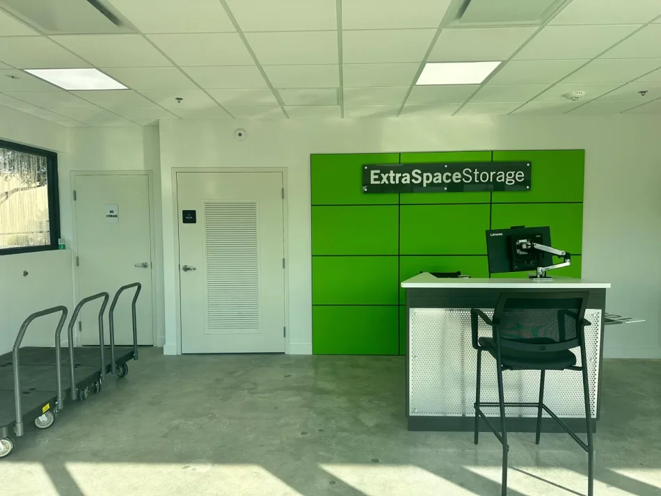 Storage facility reception office with green accent wall and service desk in Miami, FL