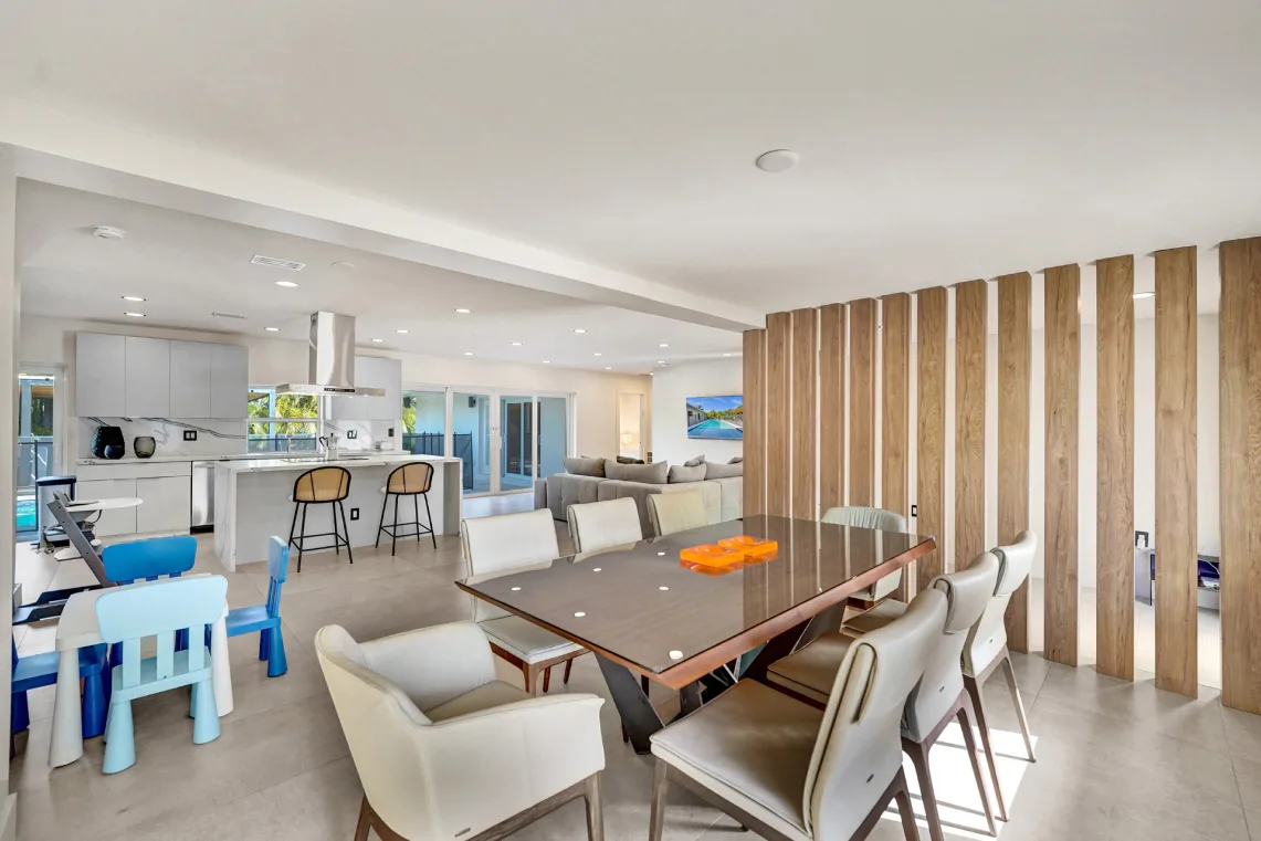 Open dining and kitchen area with wood-slat divider and children's play table